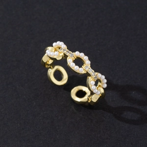 Detailed close-up of a gold-plated adjustable ring with white pearls and zircon accents