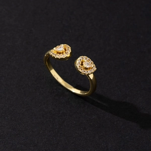 Detail of adjustable gold ring with pear-shaped cubic zirconia and micro-pave setting