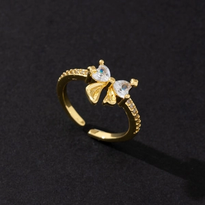 Detailed view of adjustable gold-plated ring with heart-shaped cubic zirconia butterfly