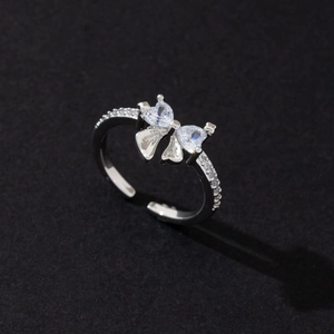 Macro shot of silver butterfly ring with pear-cut zircon stones and adjustable band