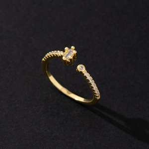 Macro shot of gold-plated open ring featuring sparkling cubic zirconia and pearl details