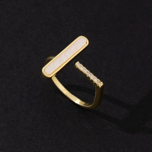 Detail of adjustable gold ring with white shell inlay and sparkling pavé zircon stones