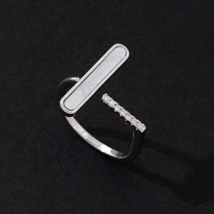 Macro view of adjustable ring featuring white mother of pearl inlay and pavé zircon stones