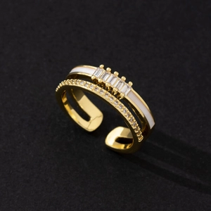 Close-up of gold double-row ring with rectangular zircons and white enamel detail