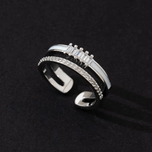 Detailed close-up of double-layer silver-tone ring with zircon stones and enamel inlay
