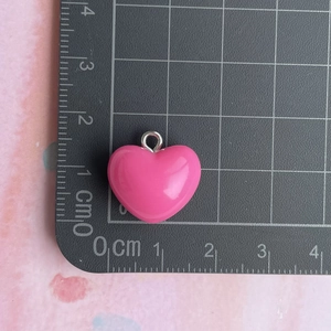Pink heart resin pendant with silver loop measured on a metric scale for DIY jewelry