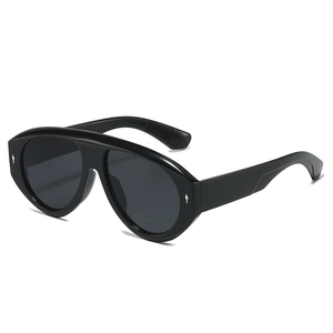 Lunettes de soleil bouclier pilotes noires avec clous en losange argentés sur fond blanc