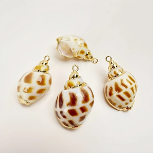 Detailed view of four natural shell pendants with elegant gold plated metal edges