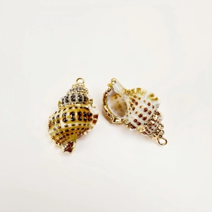 Detailed view of conch shell pendant with gold plated edges for DIY jewelry making