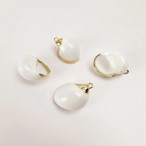 Detail view of 4 natural white shell pendants with gold plated edges for DIY jewelry