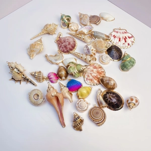 Collection of natural seashell and conch pendants with gold plated edges for DIY jewelry
