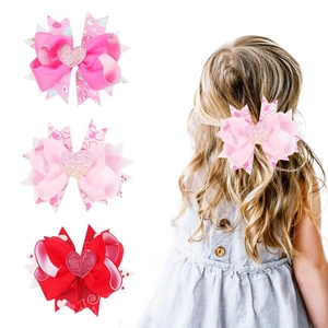 Three tiered layered ribbon bow hair clips with glitter hearts in red and pink colors