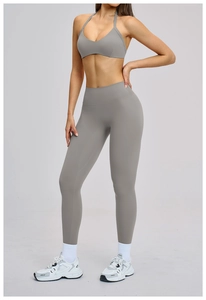 Front view of grey high waisted yoga leggings and halter sports bra set for women