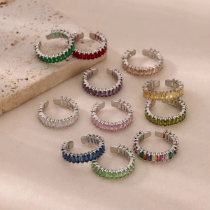 Macro detail of colorful baguette-cut zircon stones on silver adjustable rings