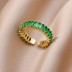 Detailed close-up of adjustable gold ring with micro-pave emerald green cubic zirconia