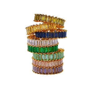 Set of seven gold plated eternity rings featuring colorful emerald cut cubic zirconia