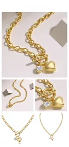 Detail of gold chain necklace featuring heart pendant and zircon stone with OT clasp