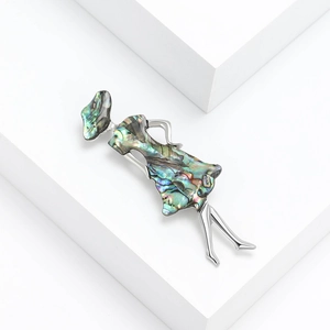 Elegant silver alloy brooch featuring a lady in a wide-brimmed hat with abalone shell inlay