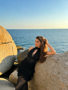 Elegant black lace halter dress with deep V-neckline and tiered ruffles for evening events