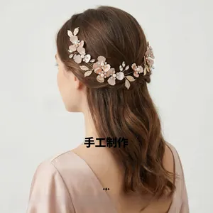 Detailed close-up of handmade bridal hair comb with pink flowers, pearls and crystals