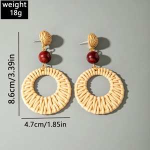 Detailed view of bohemian raffia earrings showing 8.6cm length and 18g weight specs