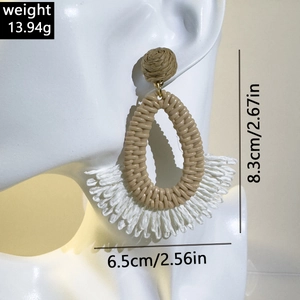 Detail view of handmade raffia drop earring with weight and size specifications