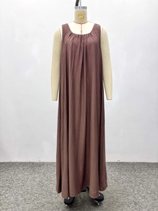 Detail of round neckline with pleated fabric on a brown sleeveless maxi dress