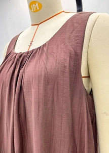 Macro detail of round neckline and pleated texture on sleeveless dusty rose maxi dress