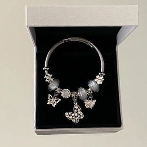 Silver beaded bracelet with crystal butterfly charms and floral beads in a premium box