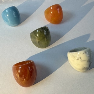 Polished acrylic resin chunky rings in various colors including amber and marble patterns