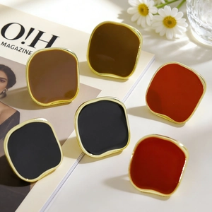 Detailed close-up of retro irregular square stud earrings with glossy red and black enamel