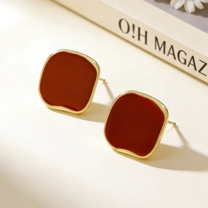 Detail shot of vintage red square stud earrings with gold plating and matte enamel finish