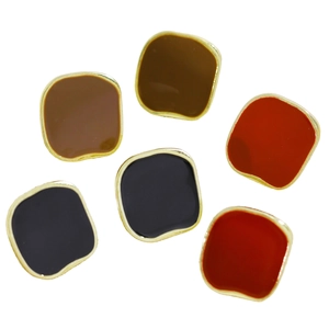 Detailed macro view of vintage square enamel rings with gold edges in red and black colors