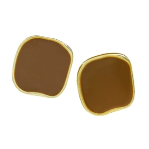 Close-up of vintage square earrings with dark enamel glaze and gold metal frame