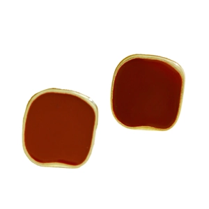 Detailed view of dark red enamel stud earrings with vintage square gold alloy base