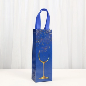 Blue non-woven wine gift bag with gold grape print and durable ribbon handles
