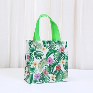 Detail of waterproof non-woven Hawaiian tote bag featuring tropical palm leaves and flowers