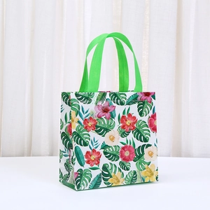 Tropical Hawaiian floral print non-woven tote bag with green handles for gift packaging