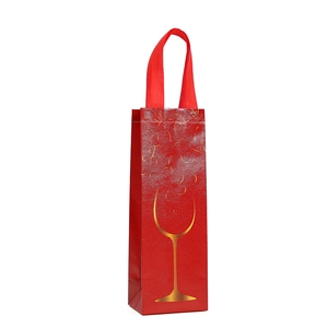 Red non-woven wine gift bag with golden wine glass silhouette and embossed texture