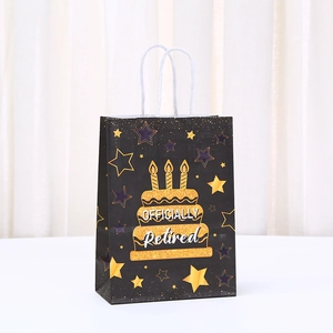 Black and gold Happy Retirement gift bag featuring a tiered cake and glitter stars