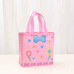 Pink non-woven gift bag featuring cartoon animal prints and polka dots with sturdy handles