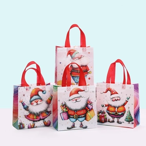 Detail of Christmas non-woven tote bags with colorful Santa Claus prints and red handles