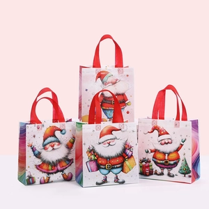 Close-up of festive Christmas non-woven gift bags with colorful Santa Claus patterns