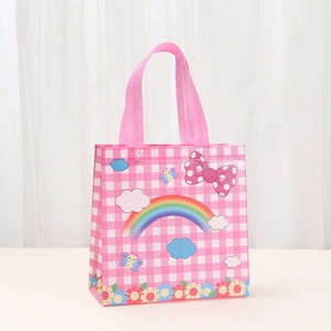 Detailed view of pink plaid non-woven gift bag with rainbow, clouds and bow patterns