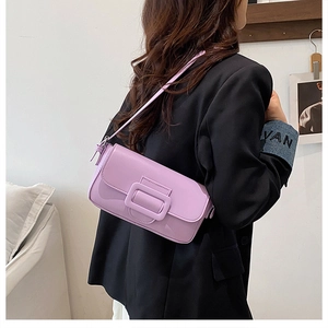Close-up of lavender leather shoulder bag featuring a large square buckle and rectangular shape