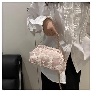 Close-up of pink satin shell bag with 3D floral embroidery and gold metal chain strap