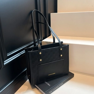 Minimalist black tote bag with checkered texture and gold rivet details for women