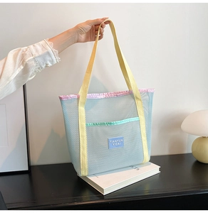 Detailed macro view of light blue mesh tote bag with durable pastel color woven straps
