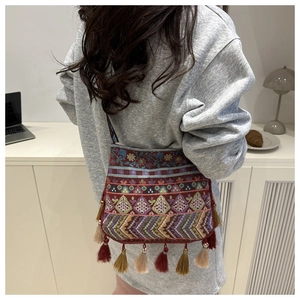 Detailed embroidery and colorful tassels on an ethnic style crossbody shoulder bag
