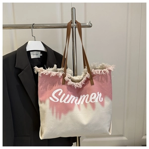 Detail of pink gradient canvas tote bag featuring Summer print and tassel edges
